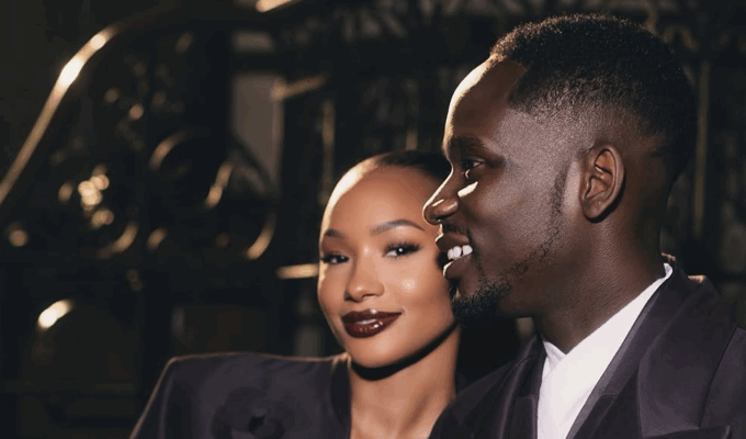 Temi Otedola and Mr Eazi in matching deep plum Casablanca satin suits at Paris Fashion Week