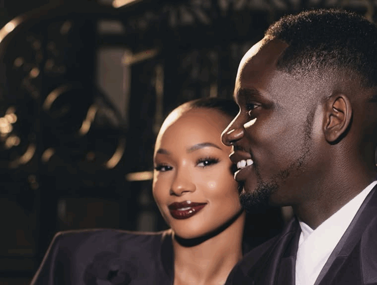 Temi Otedola and Mr Eazi in matching deep plum Casablanca satin suits at Paris Fashion Week