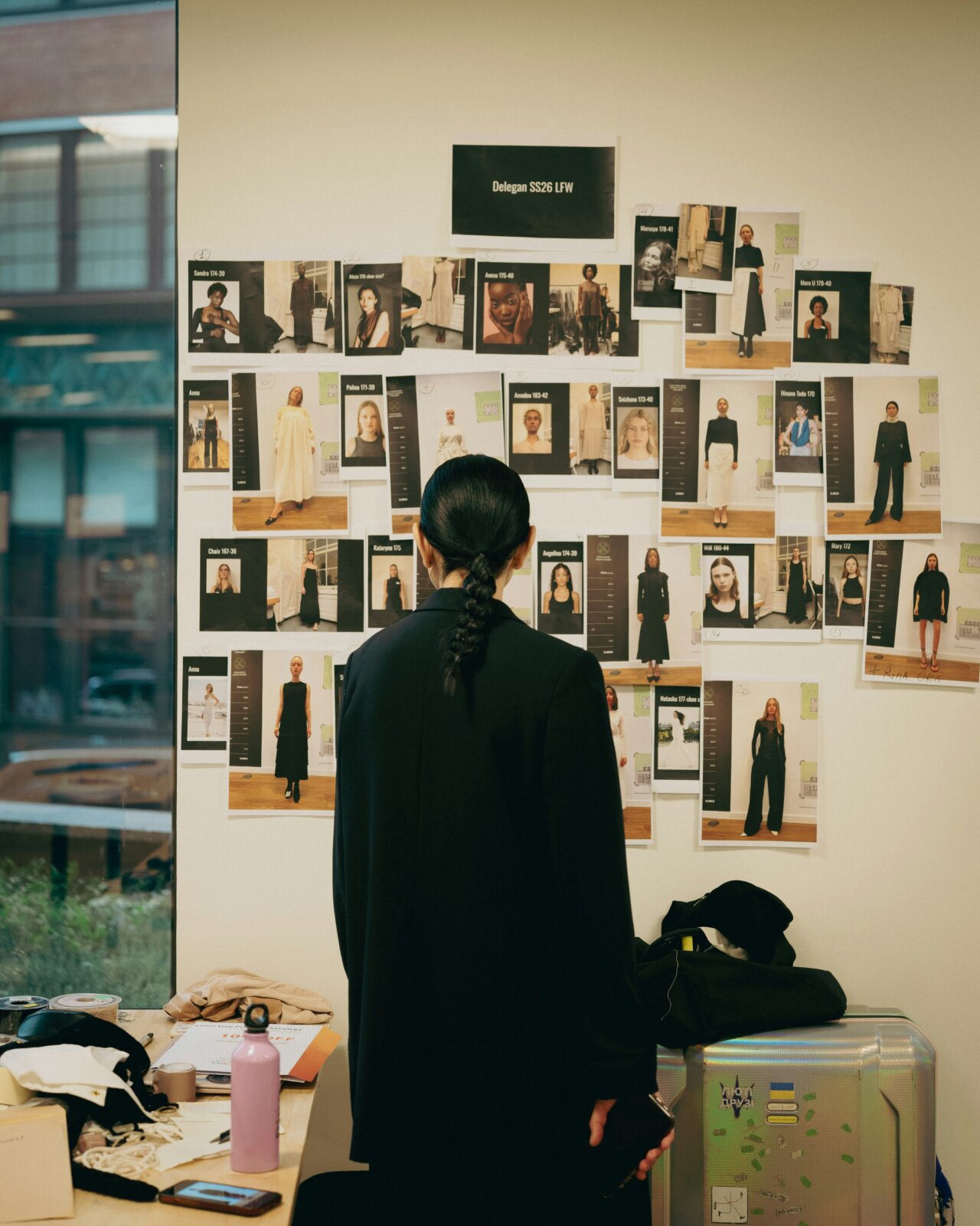 Designer standing in front of fashion moodboard by Metin Ozer via Unsplash
