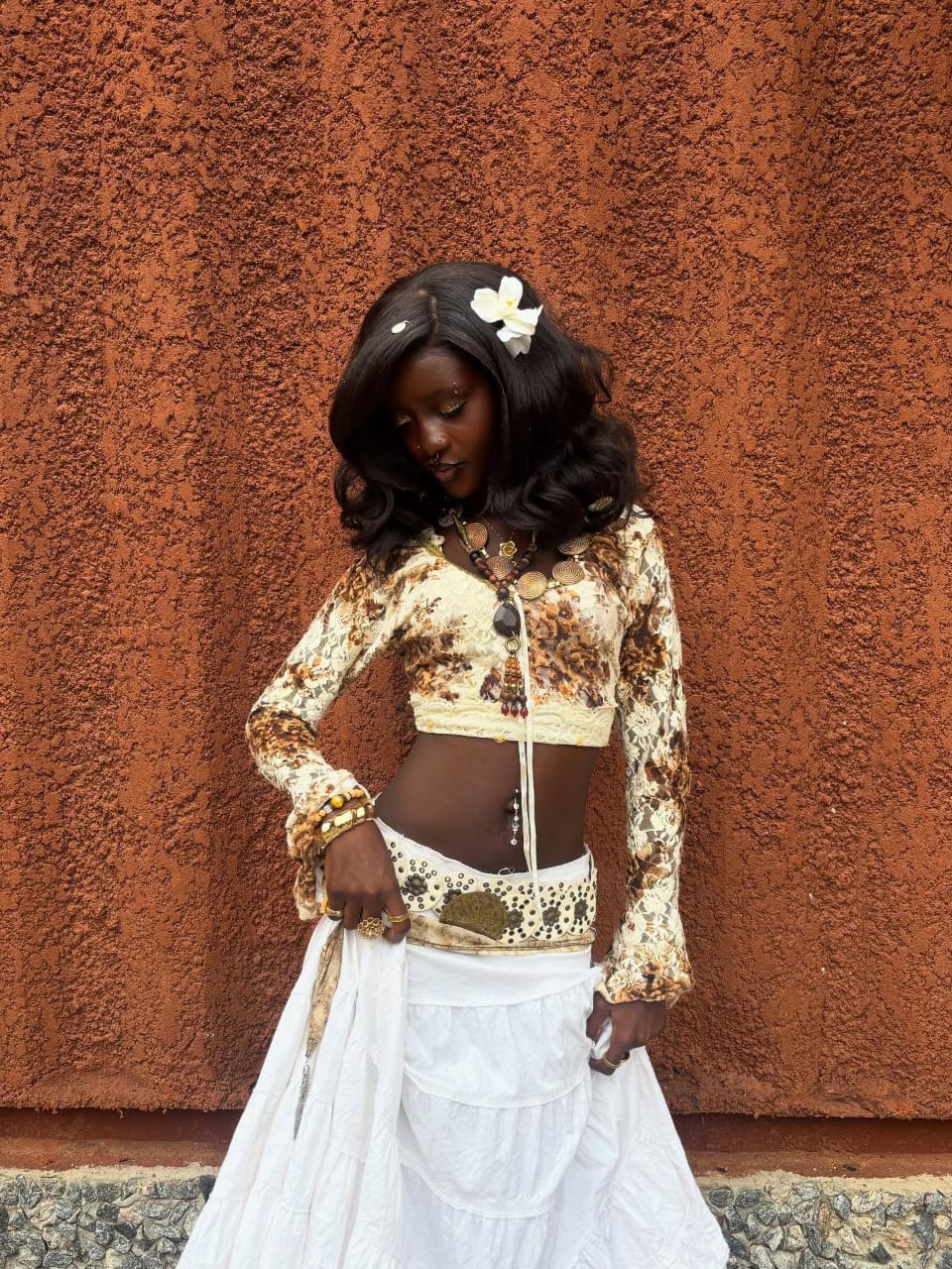 Omoloto in a boho skirt and brown blouse