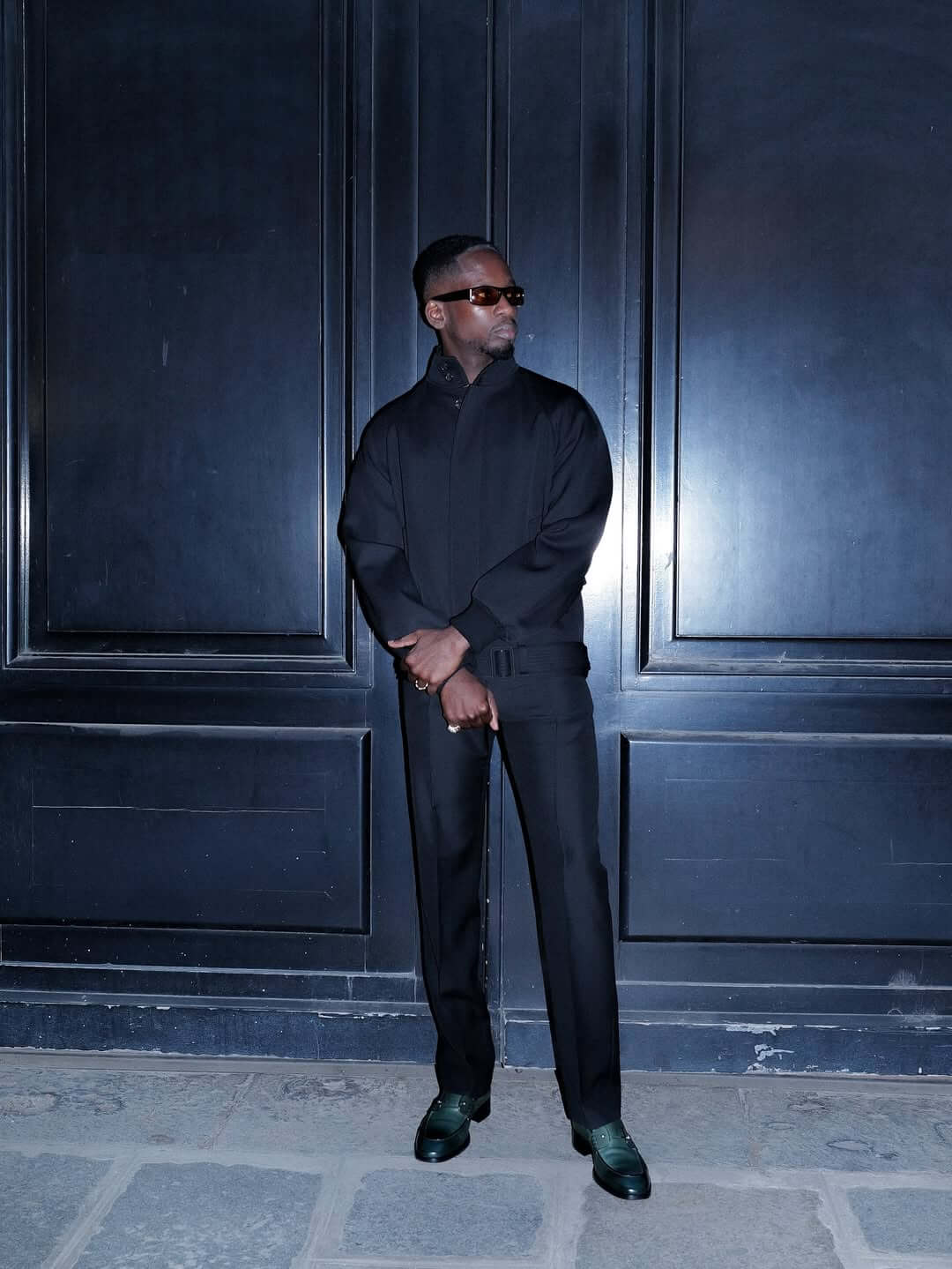 Mr Eazi in a black tailored suit at the Christian Louboutin show