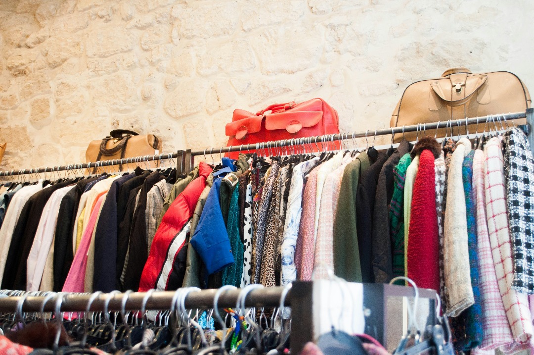 Vintage clothes and bags on hangers