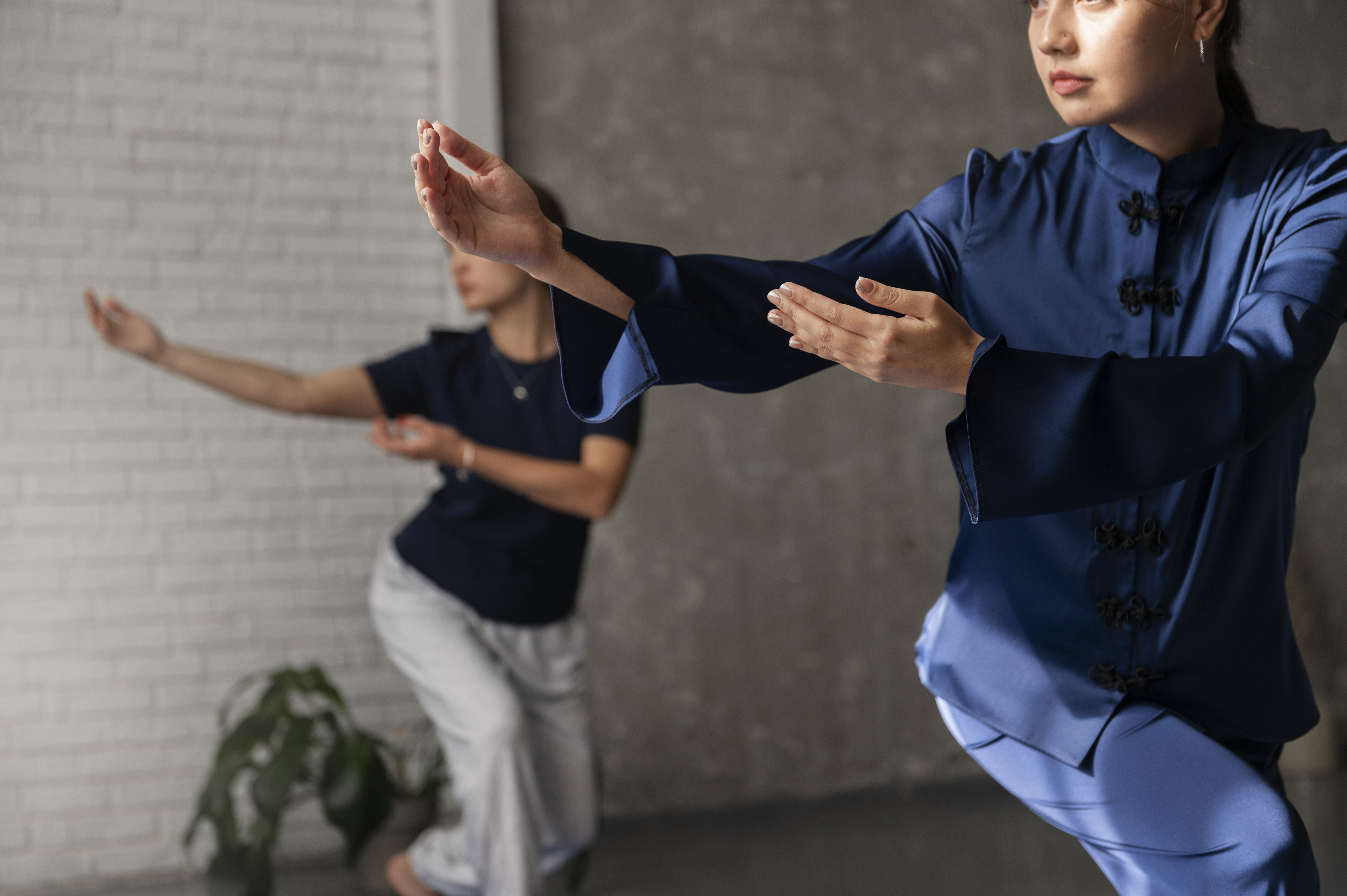 Women practicing Tai Chi via Freepik
