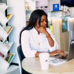 Hustle Culture: A woman working on her laptop by ninthgrind via Unsplash