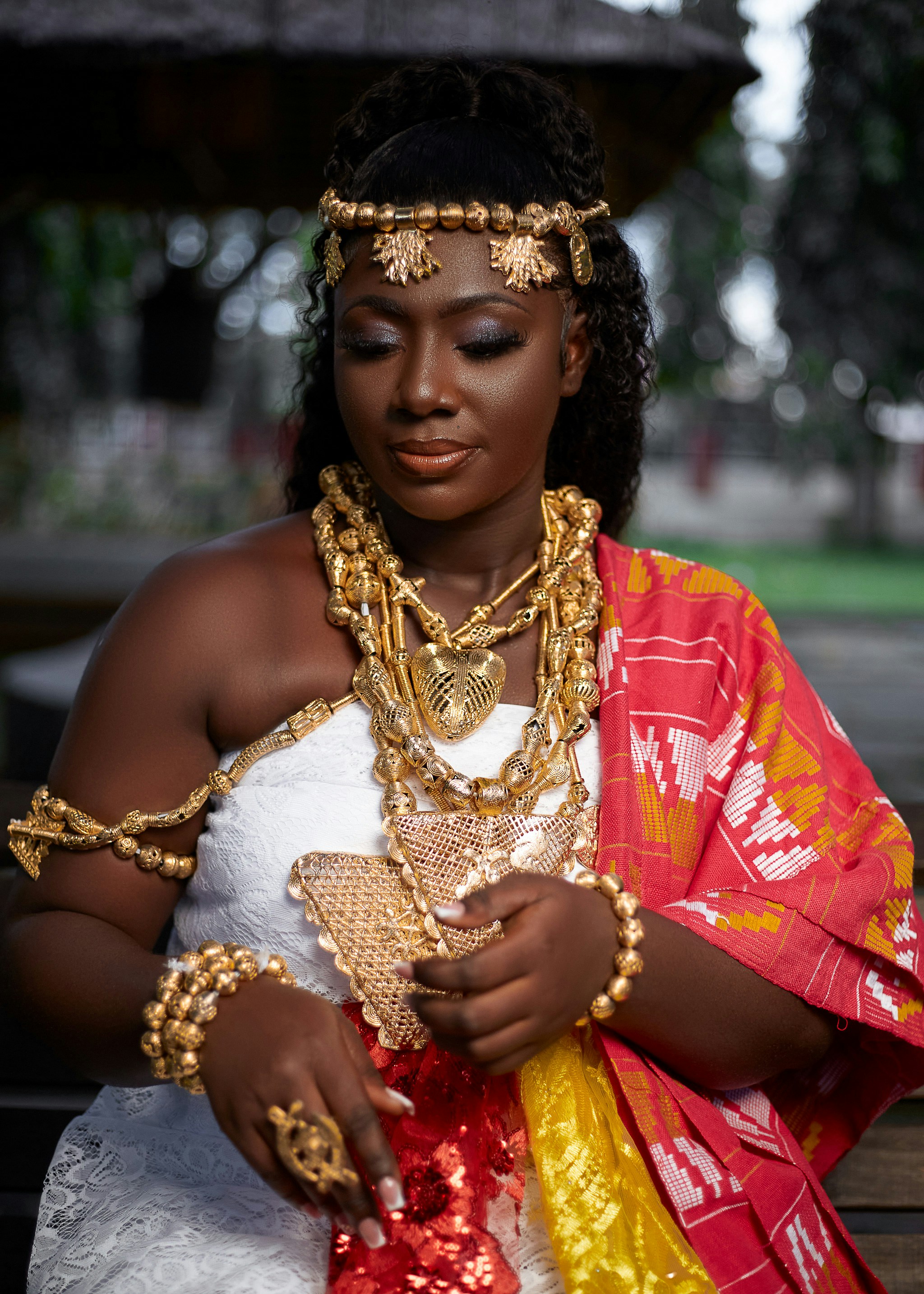 Woman in traditional attire with gold by Qweraqu McBrew via Unsplash