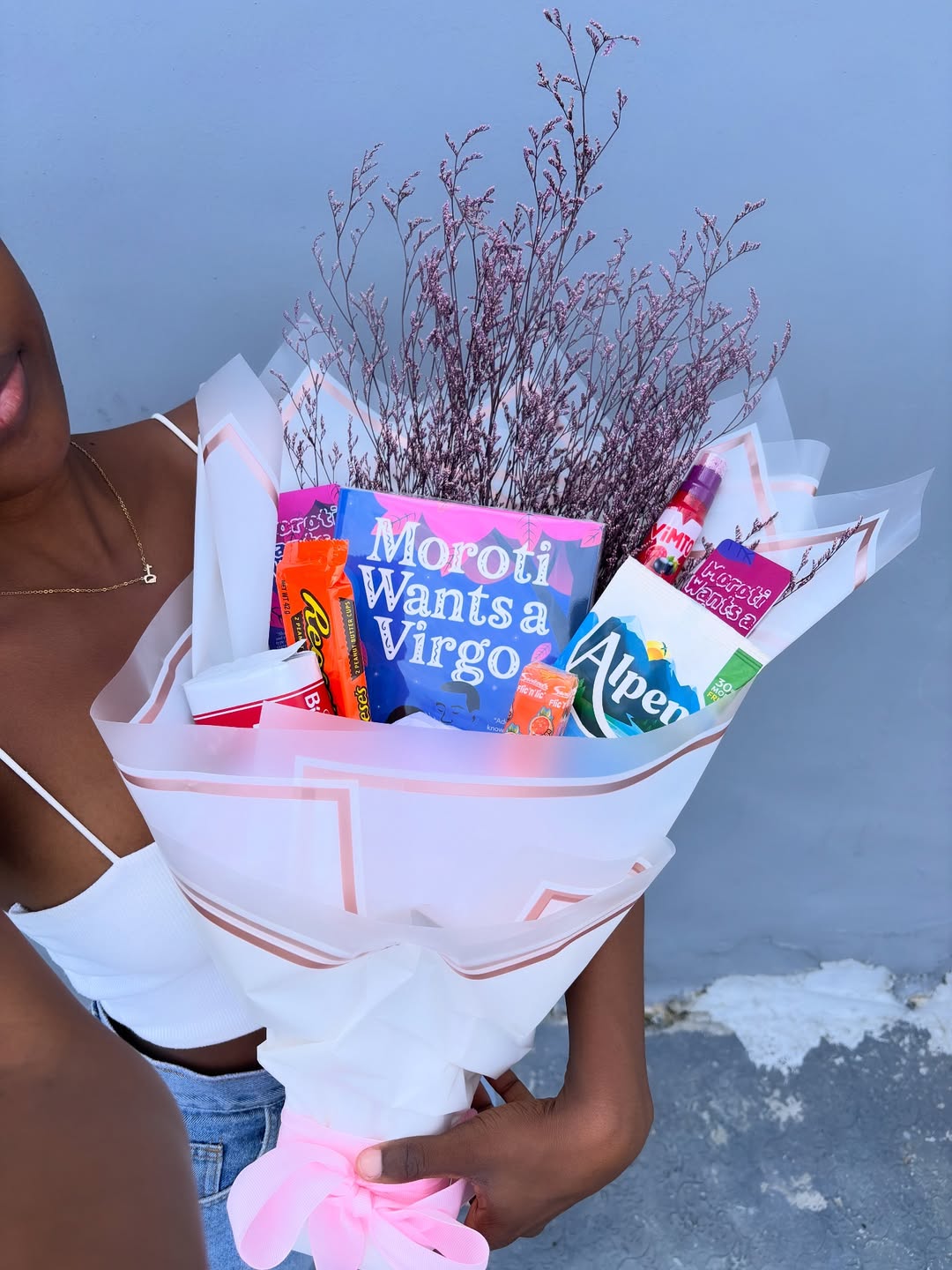 Black girl holding a book bouquet via @msliterarylover on Instagram