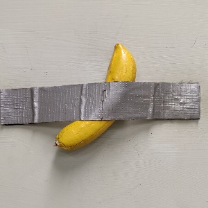 Banana duct taped to wall art