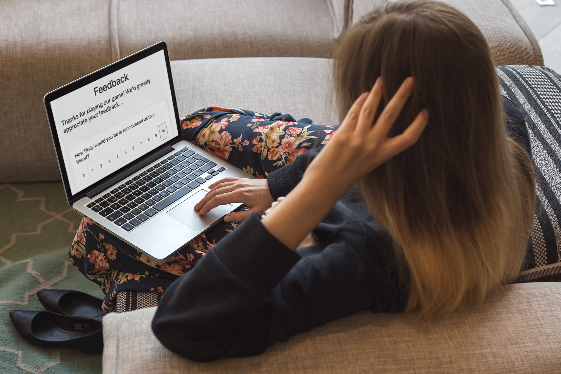 A woman looks at a survey form on a laptop