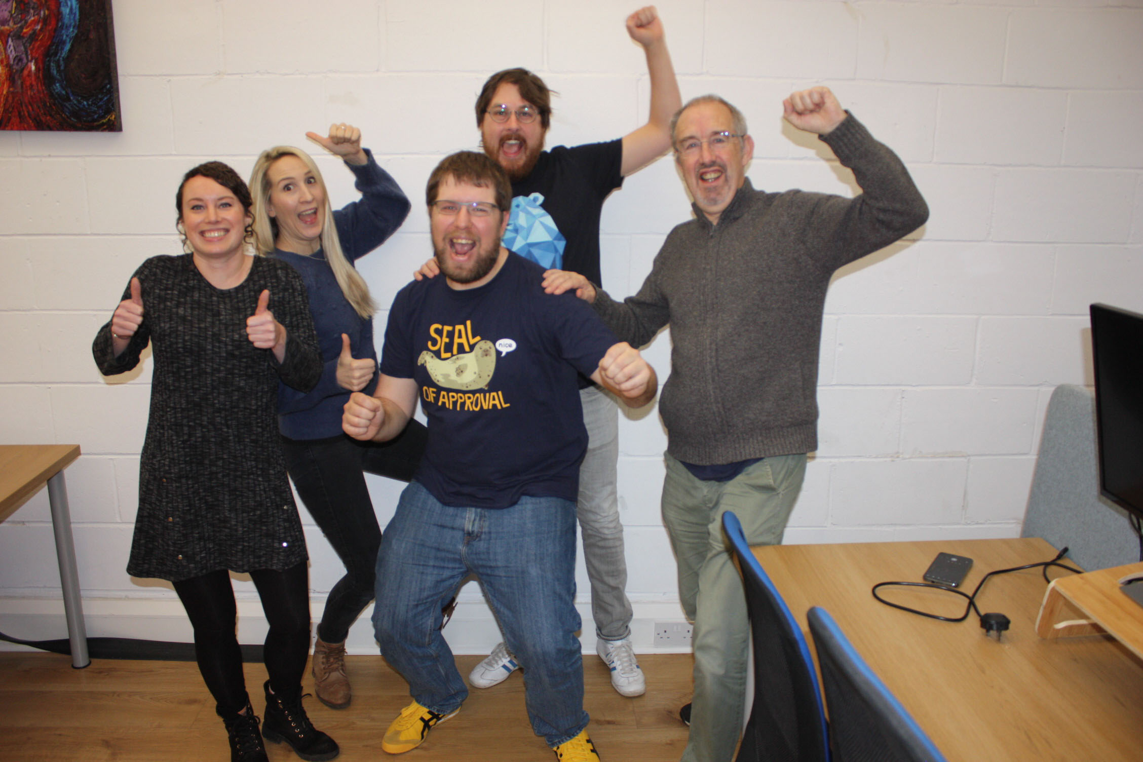 Escape room happy group with chair and desk cluttering up the picture