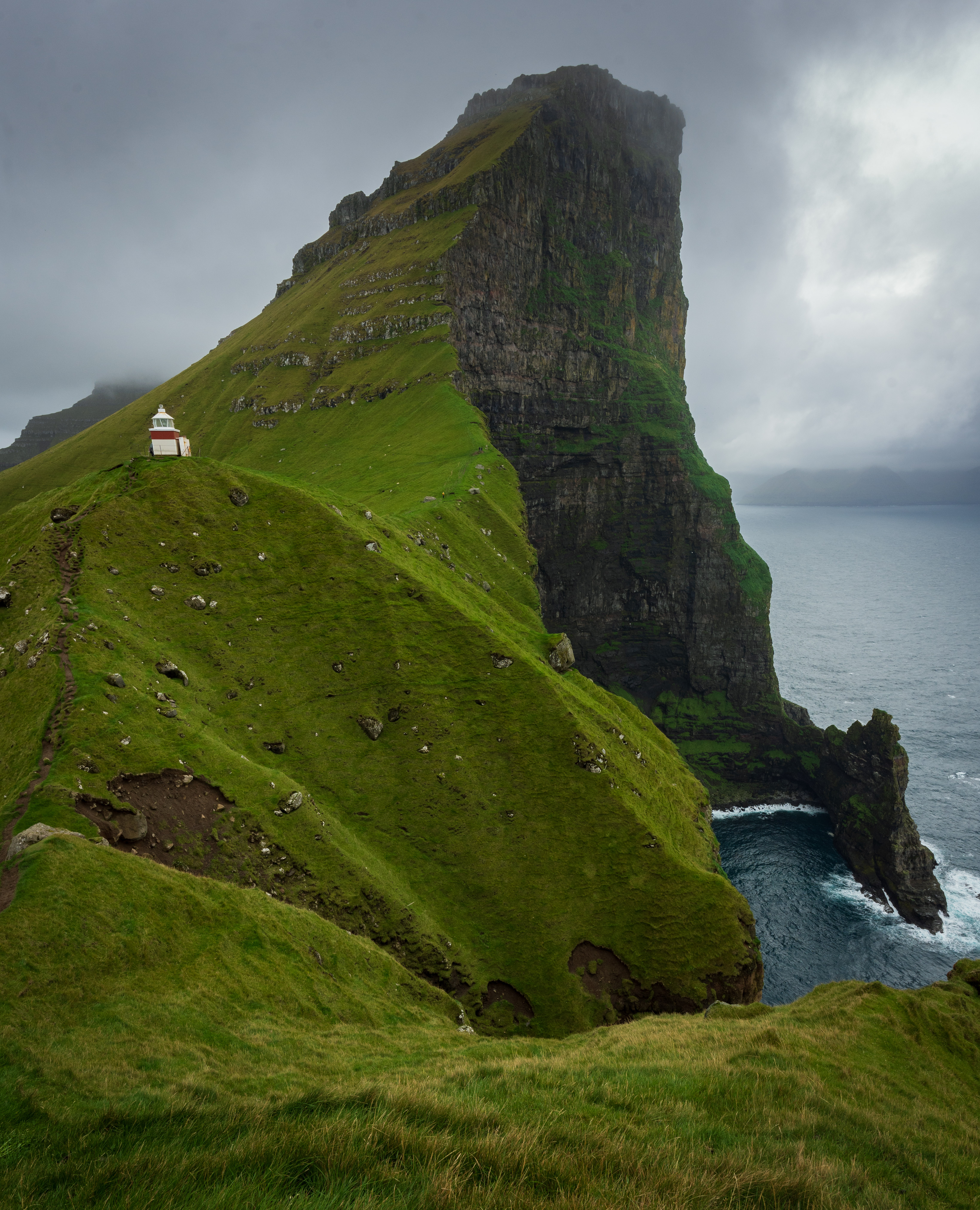 The iconic view of the lighthouse with the cliff in the background.