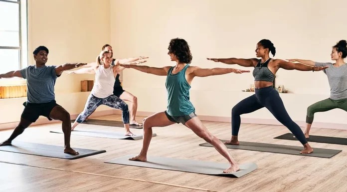 people practicing yoga moves in a room