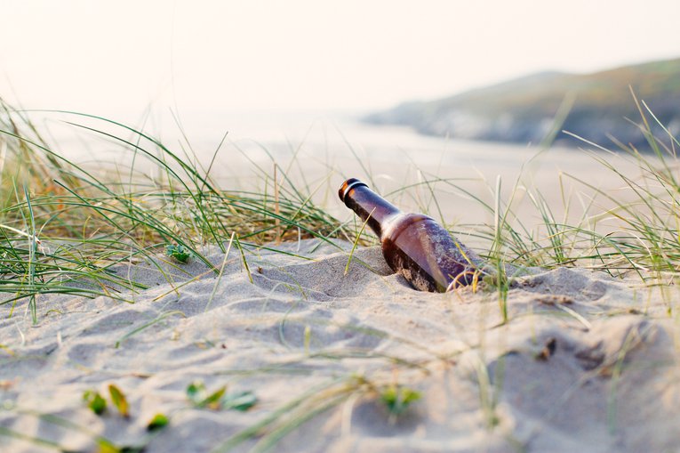 Beer bottle litter on Crantock beach Cornwall Natasha Ewins