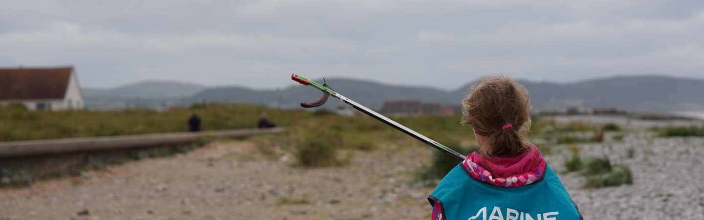 Young beach cleaner with litter picker