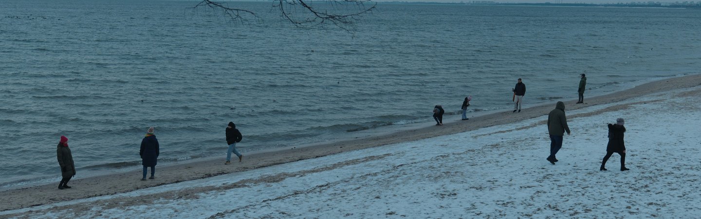 People walking on wintry beach