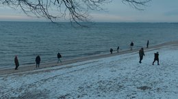 People walking on wintry beach