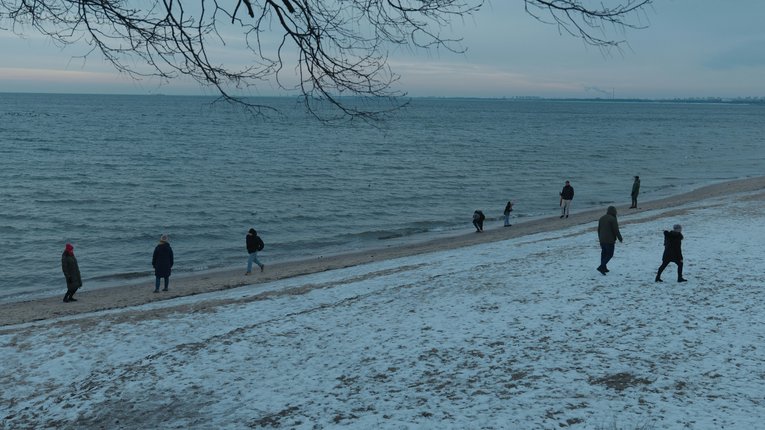 People walking on wintry beach