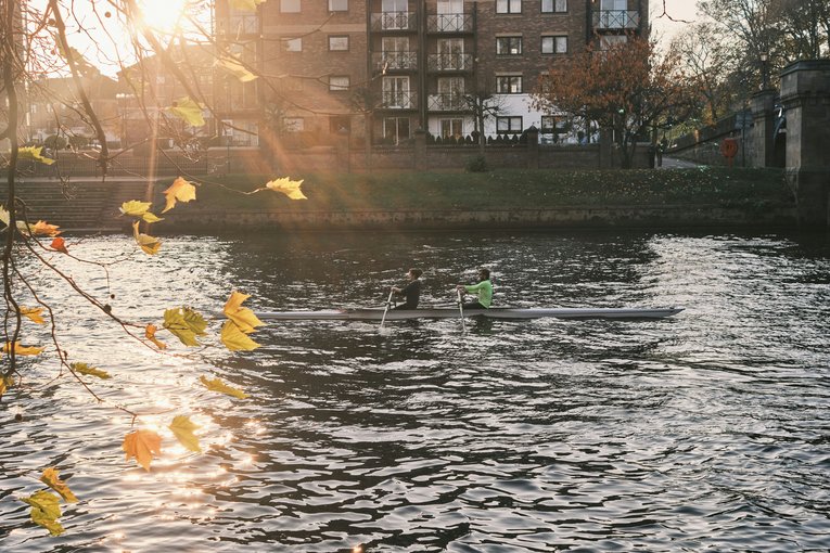 People canoeing down a river in York