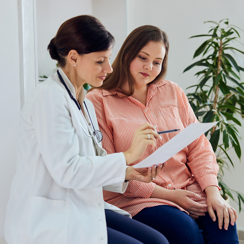 Doctor talking to a person with a chart