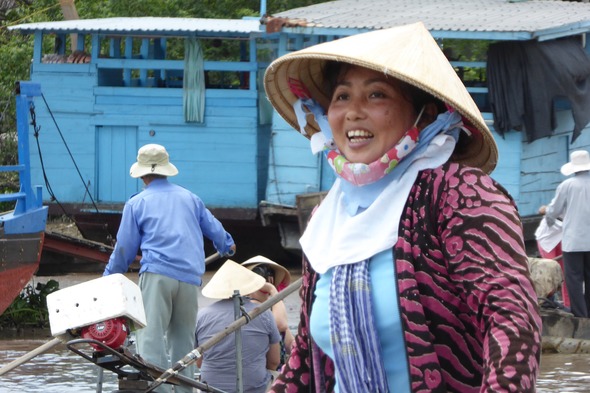 Happy lady on the Mekong in Cai Be, Vietnam