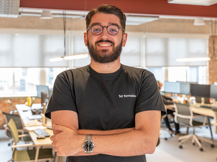 James Dobran, 1st Formations staff standing facing camera wearing 1st Formations branded t-shirt.