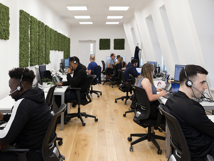 Scaled back shot of various staff members working in the London office.