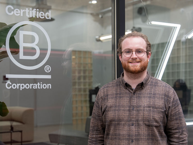 1st Formations staff Humza looking at camera and smiling.