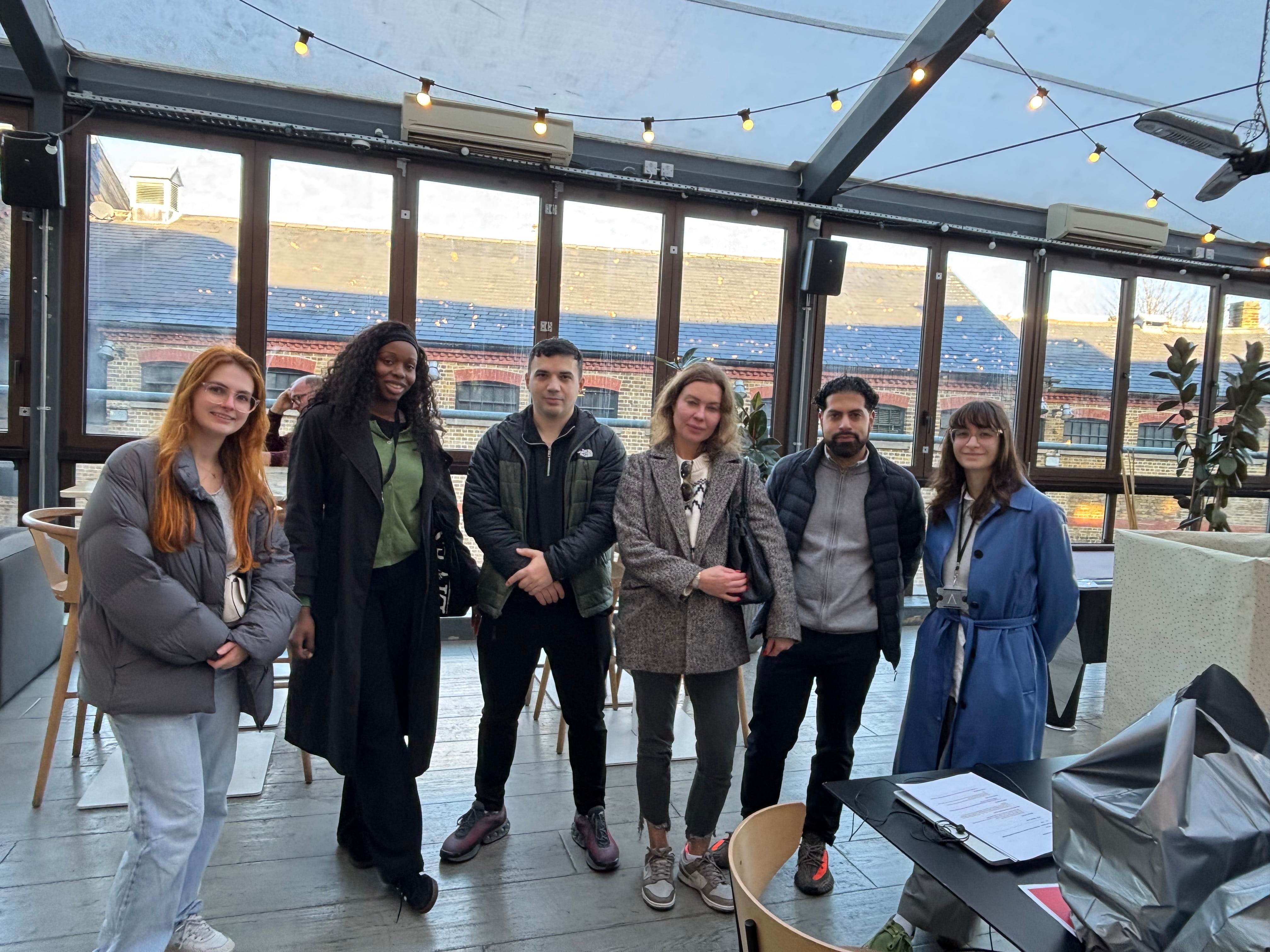 A group photo of our staff members on a volunteering day within a conservatory.