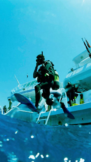Diver jumping off boat