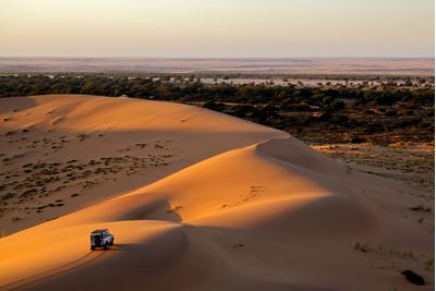 Driving sand dune desert safari at sunset, Dubai