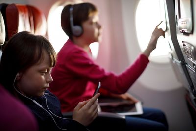 children watching films on an airplane