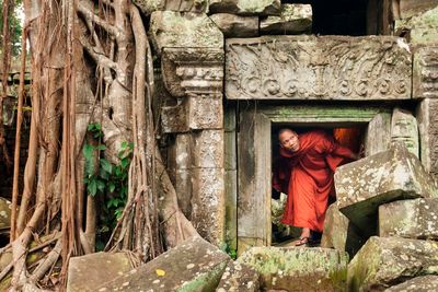 a monk climbing out of a temple