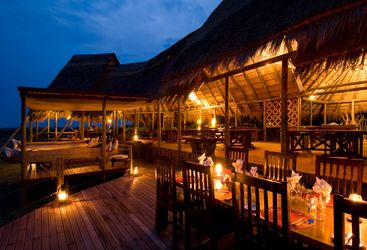 Dining at the camp verandah at Selinda Camp, luxury camp in Botswana