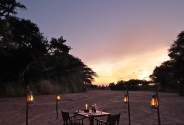 Dinner on the sandriver at Jongomero, luxury hotel in Tanzania
