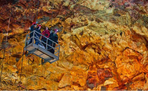 Family going down the lift into the volcano crater