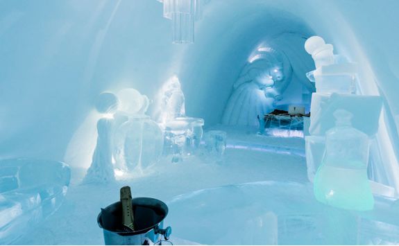 Enjoy champagne in the Icehotel room