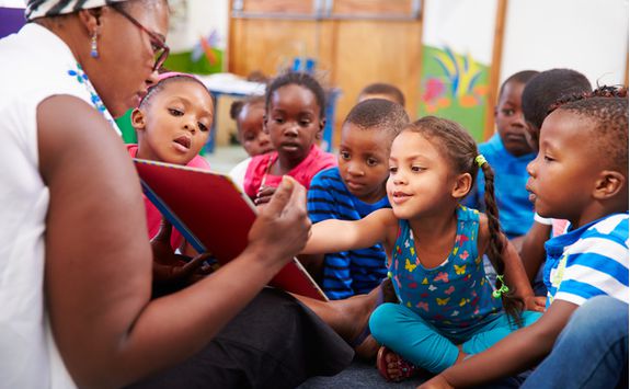 children and teacher in township
