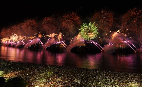 Evening fireworks over crowds