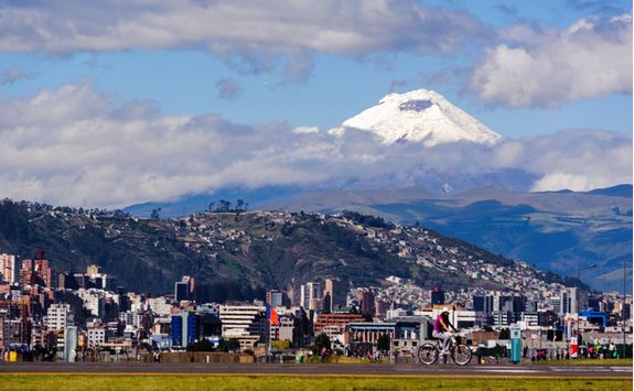 a view of Quito with a volcano in the background