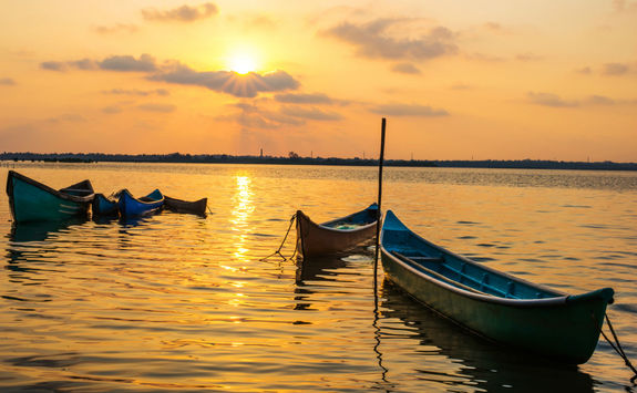 Small fishing boats at sunset