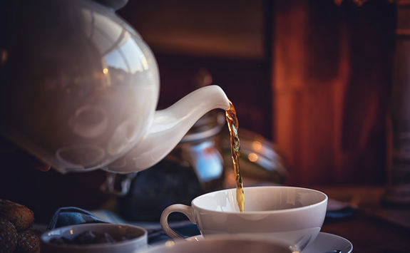 Pouring tea into a cup