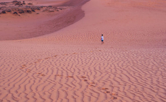Child in the desert dunes