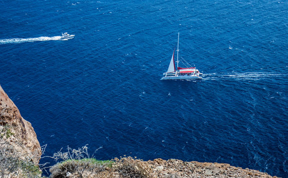 Catamaran and speedboat out at sea