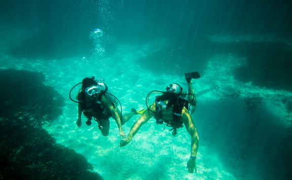 couple diving underwater