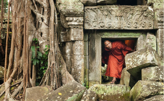 Monk exploring old ruins