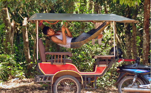 man chilling hammock of tourist carriage