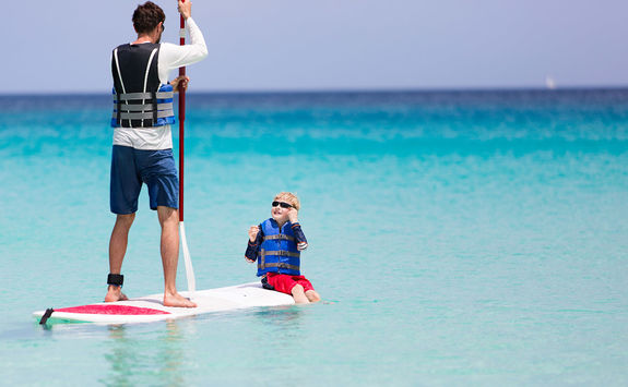 Paddleboarding father and son