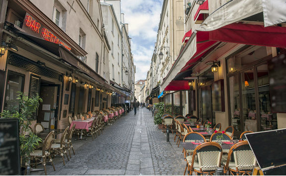 Empty dining tables and chairs in Paris