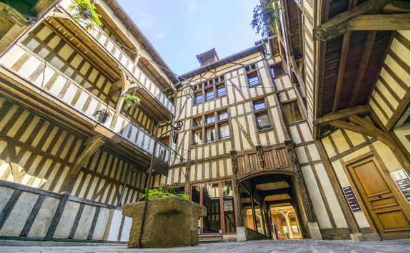 Medieval courtyard surrounded by half medieval houses