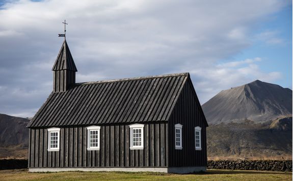Black church with volcano at background