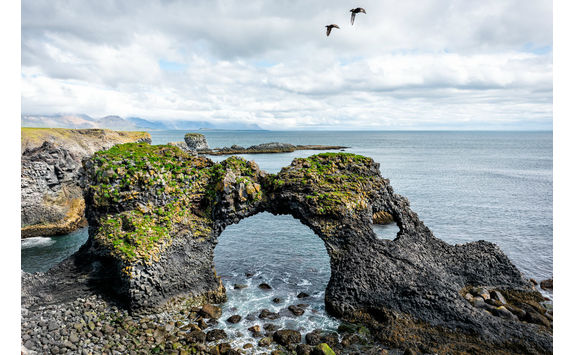 Gatklettur arch rock with two birds fly